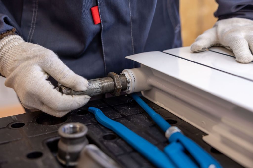 Plumber connecting a radiator pipe
