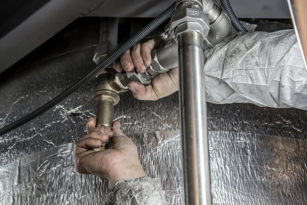Hands fitting a pipe joint