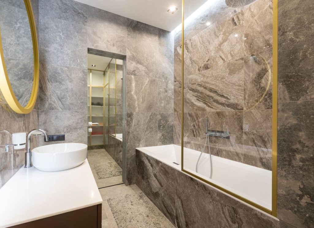 Marble bathroom with a vanity and a bathtub
